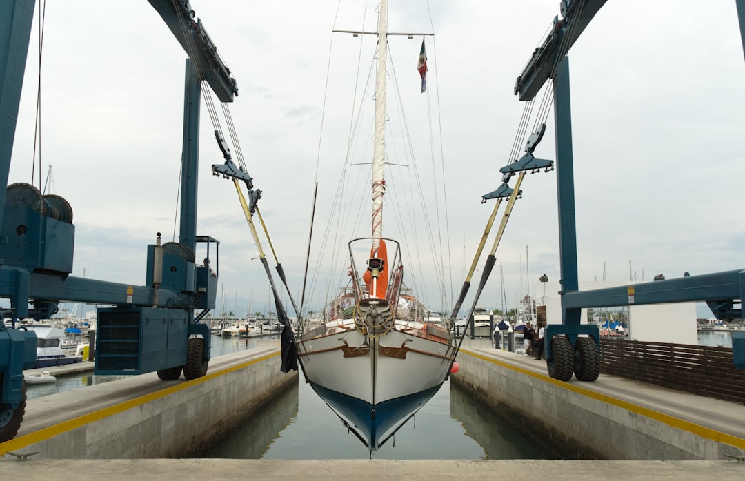 a boat docked at a dock in the water oj087evshsy.jpeg